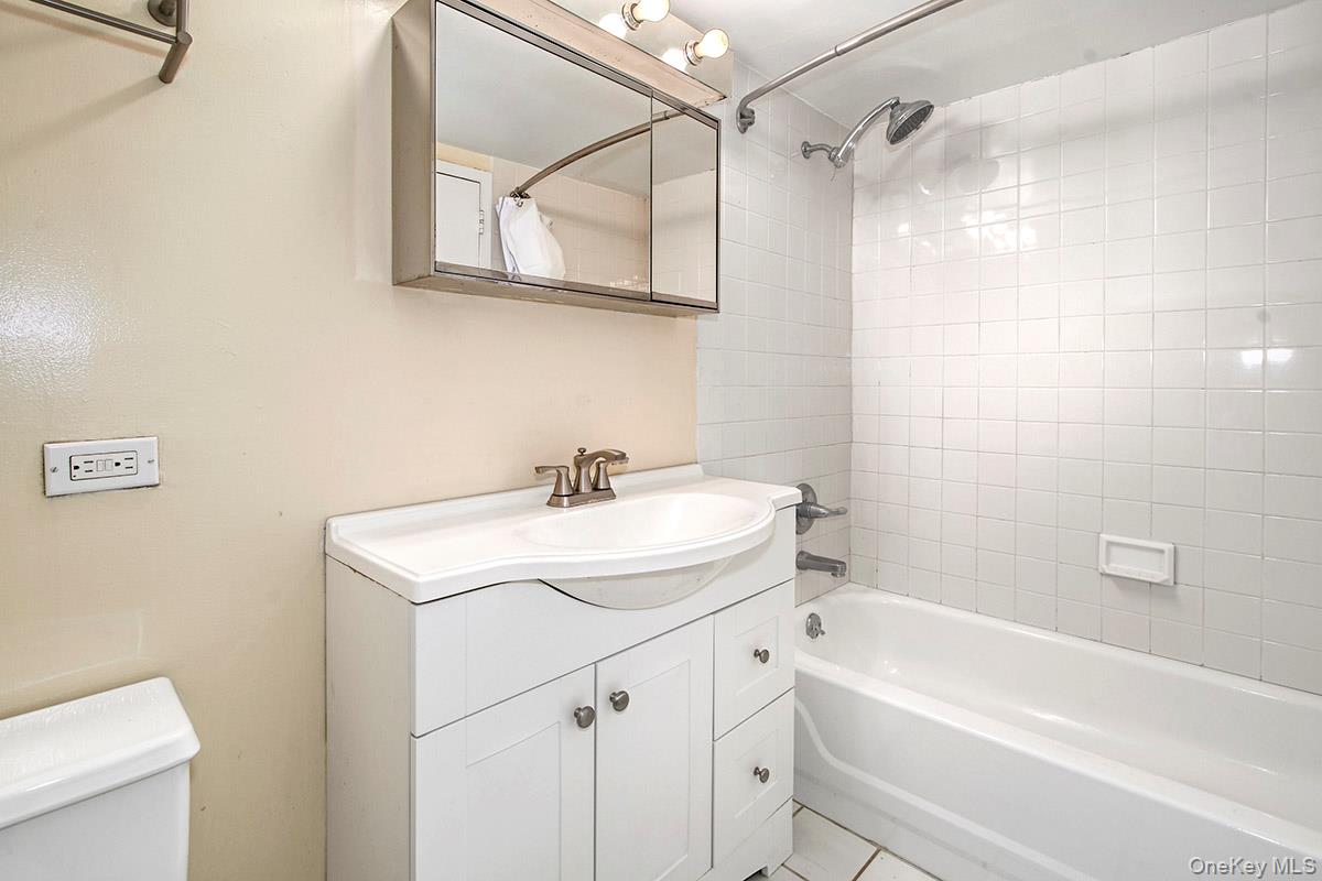 1 Landmark Square, Unit 109 Port Chester, NY 10573 - Photo 15 of 24 a bathroom with a sink a mirror toilet and bathtub