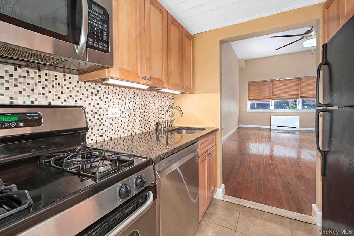 1 Landmark Square, Unit 109 Port Chester, NY 10573 - Photo 8 of 24 a kitchen with a stove and a refrigerator