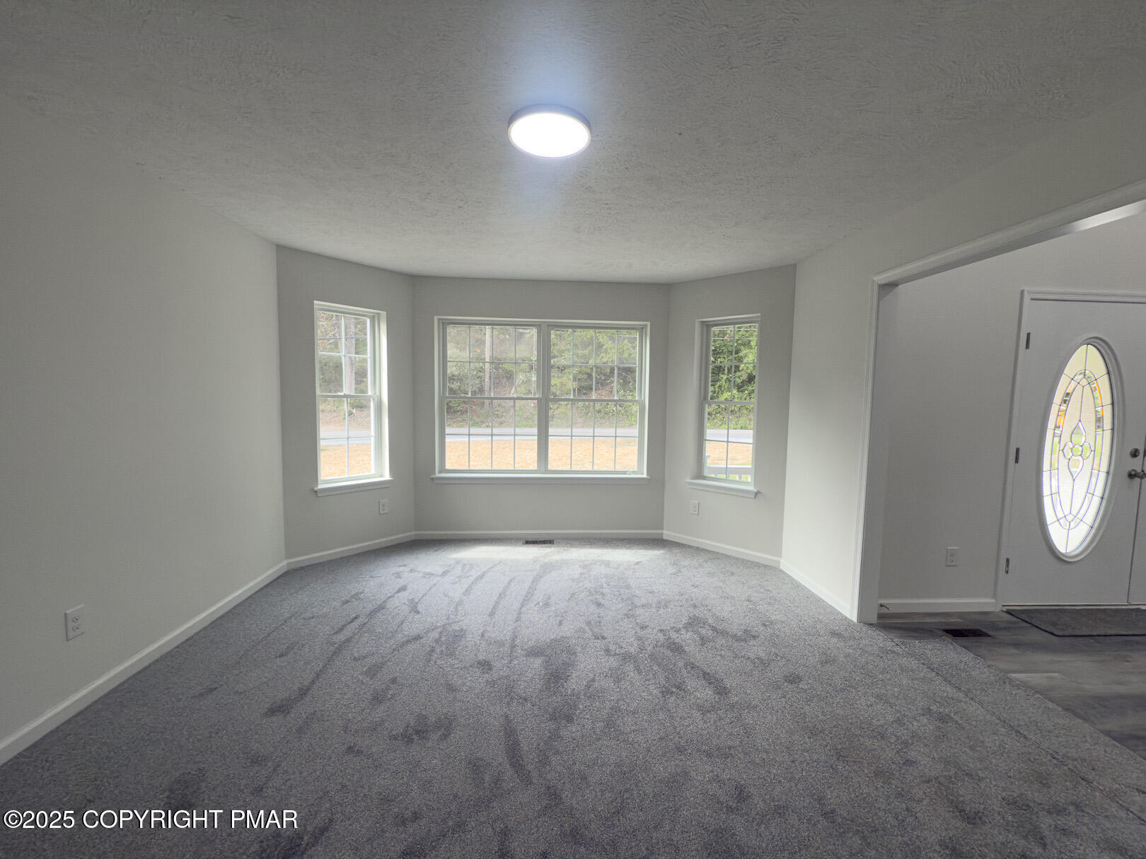 264 Mc Cole Road East Stroudsburg, PA 18302 - Photo 8 of 35 an empty room with windows and mirror