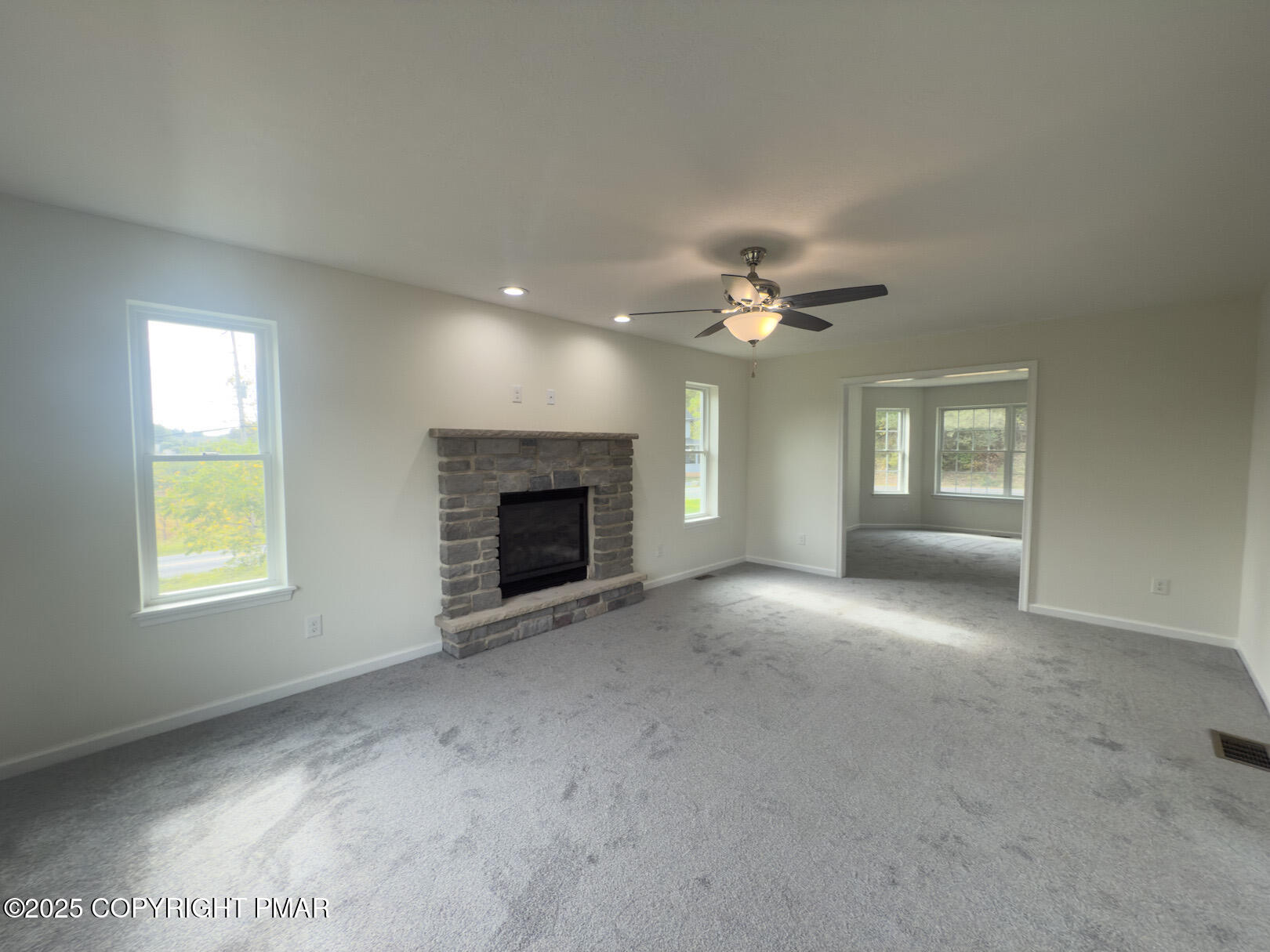 264 Mc Cole Road East Stroudsburg, PA 18302 - Photo 10 of 34 a view of an empty room with chandelier fan and fire place