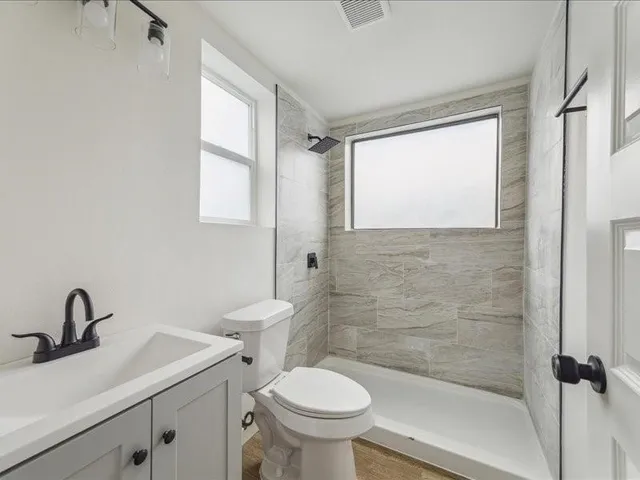 a bathroom with a sink toilet and a mirror