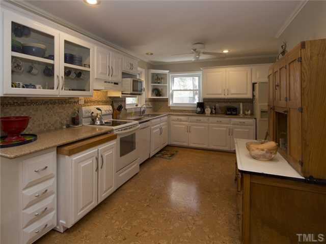 910 Lake Boone Trail Raleigh, NC 27607 - Photo 8 of 25 Kitchen is spacious and eat in can fit nicely where hutch is located. There is also space behind hutch for possible future expansion. Kitchen