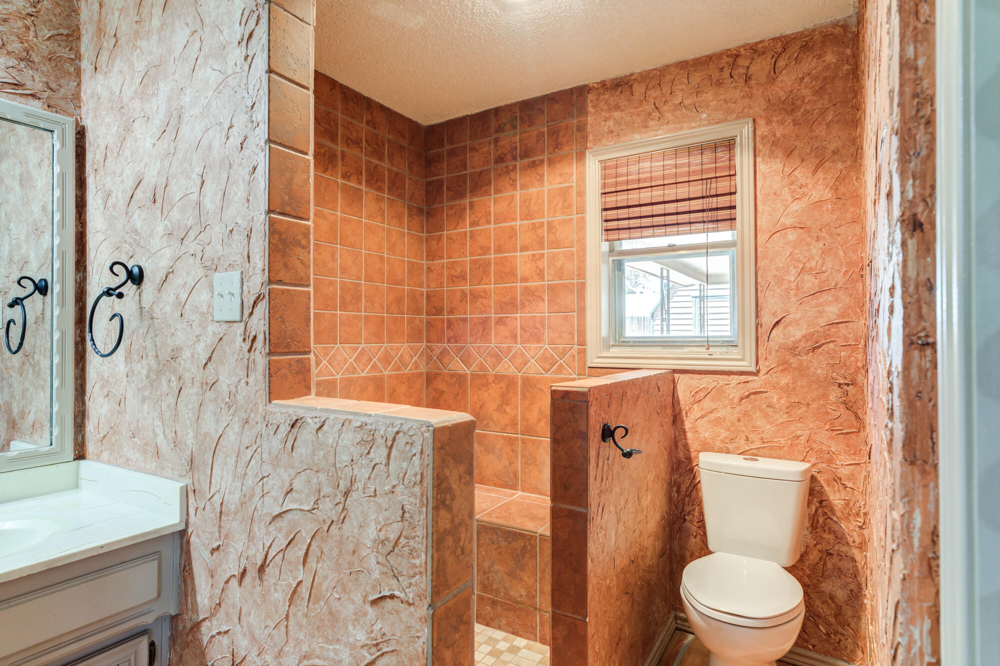 5523 74th Street Lubbock, TX 79424 - Photo 12 of 18 a bathroom with a toilet and a shower