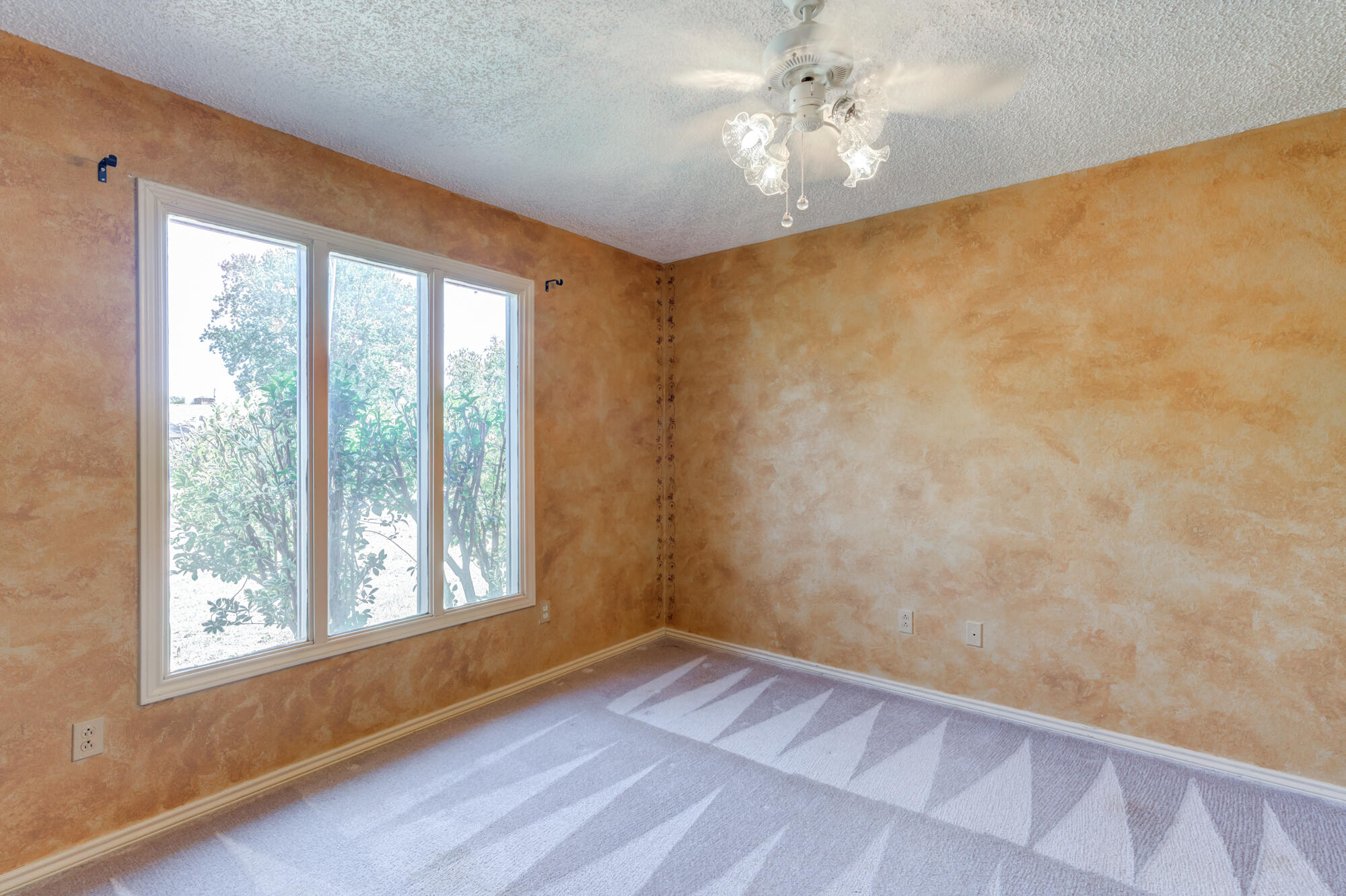 5523 74th Street Lubbock, TX 79424 - Photo 14 of 18 wooden floor in an empty room with a window