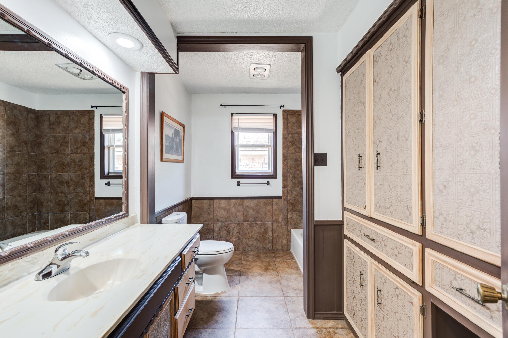 5523 74th Street Lubbock, TX 79424 - Photo 15 of 18 a bathroom with a sink a toilet and shower