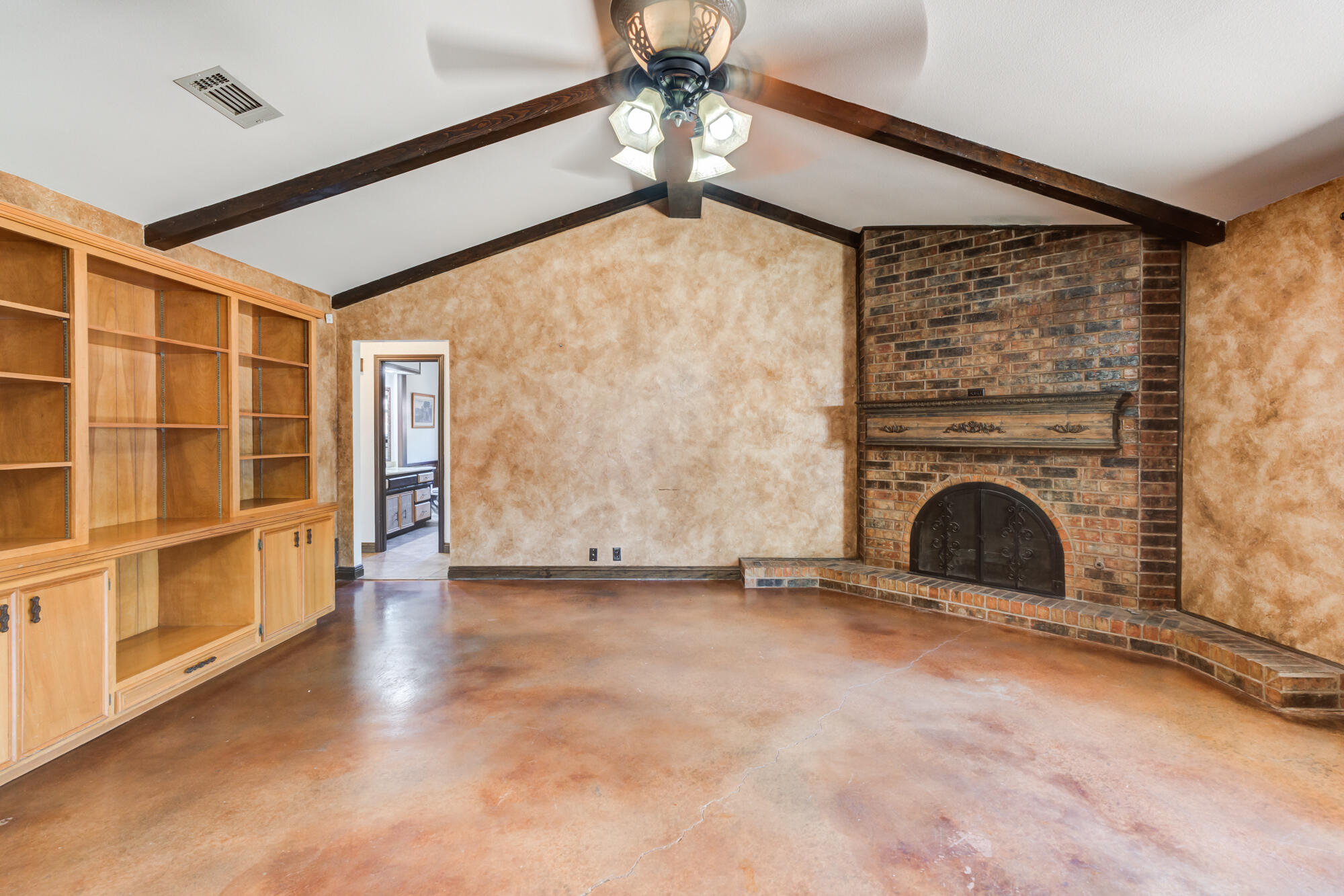 5523 74th Street Lubbock, TX 79424 - Photo 3 of 18 a view of empty room with fireplace and windows