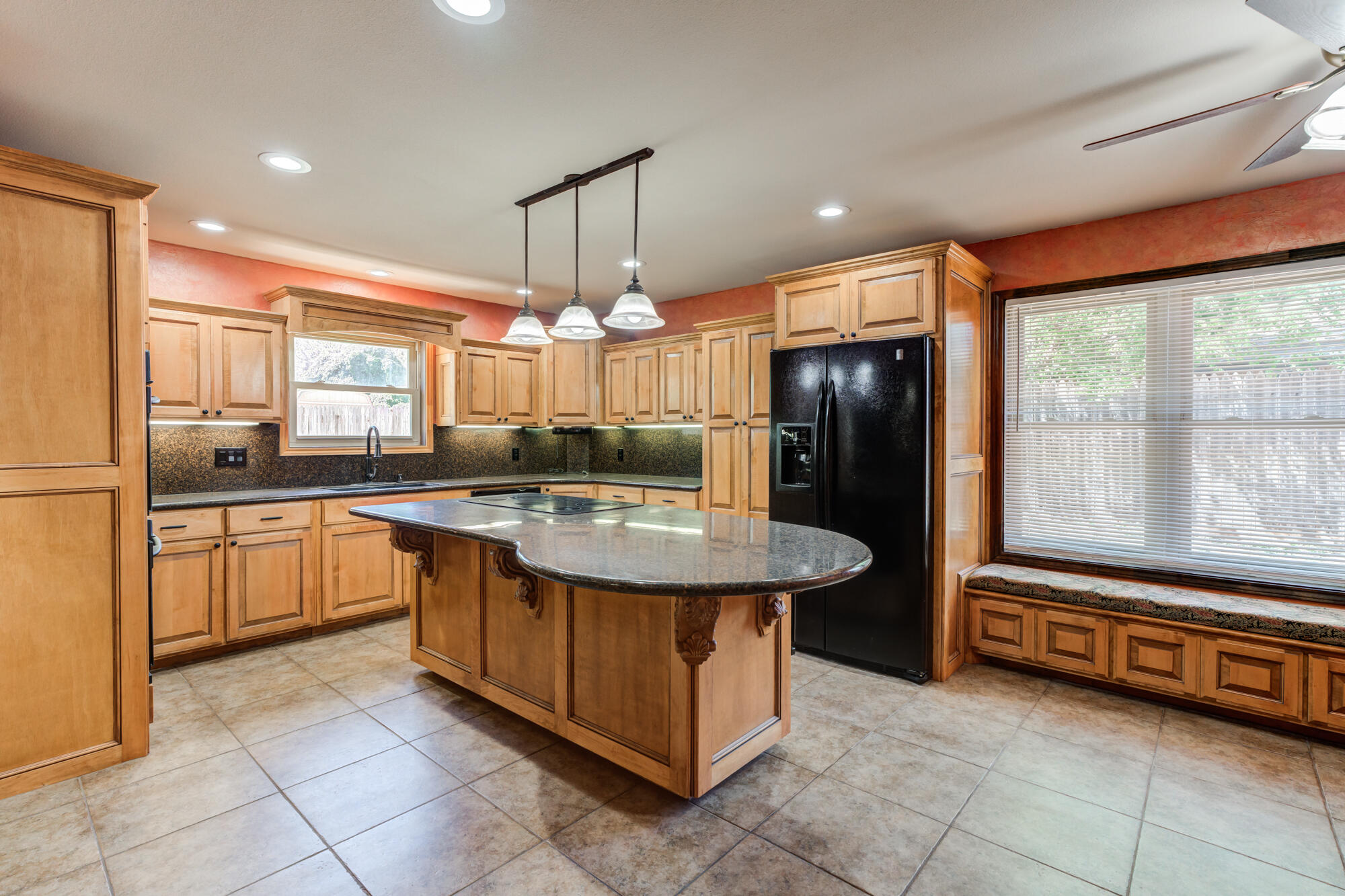 5523 74th Street Lubbock, TX 79424 - Photo 5 of 18 a kitchen with kitchen island granite countertop a sink counter and refrigerator