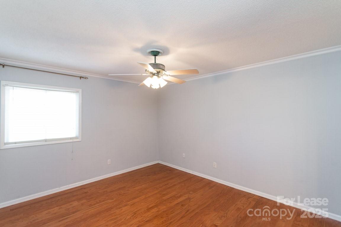 140 Lake Concord Road Northeast, Unit B4 Concord, NC 28025 - Photo 13 of 23 an empty room with wooden floor and windows