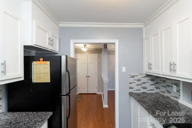 a view of a kitchen cabinets and a counter top space