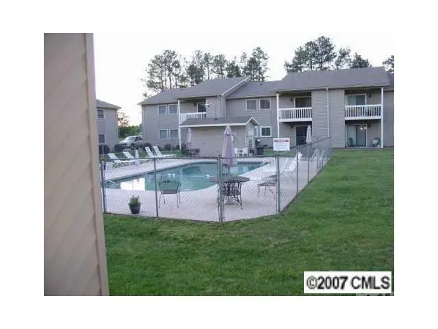 a view of a house with a yard and a patio