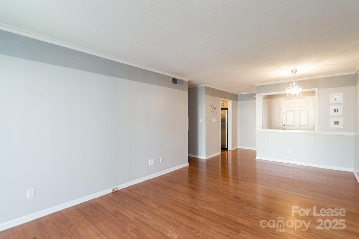 140 Lake Concord Road Northeast, Unit B4 Concord, NC 28025 - Photo 8 of 23 a view of an empty room with wooden floor and a window