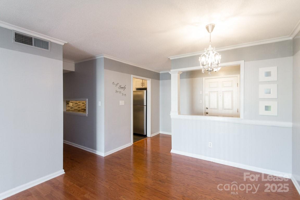 140 Lake Concord Road Northeast, Unit B4 Concord, NC 28025 - Photo 9 of 23 wooden floor in an empty room with a window