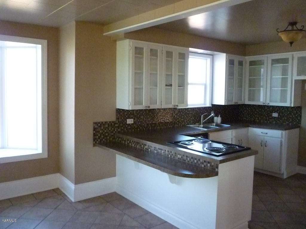 3020 Fort Road Toppenish, WA 98948 - Photo 11 of 37 a kitchen with granite countertop a sink and a stove top oven