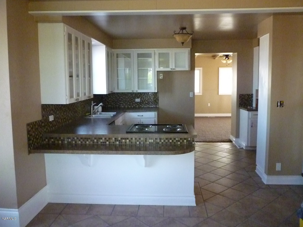 3020 Fort Road Toppenish, WA 98948 - Photo 12 of 37 a kitchen with granite countertop a refrigerator and a stove top oven