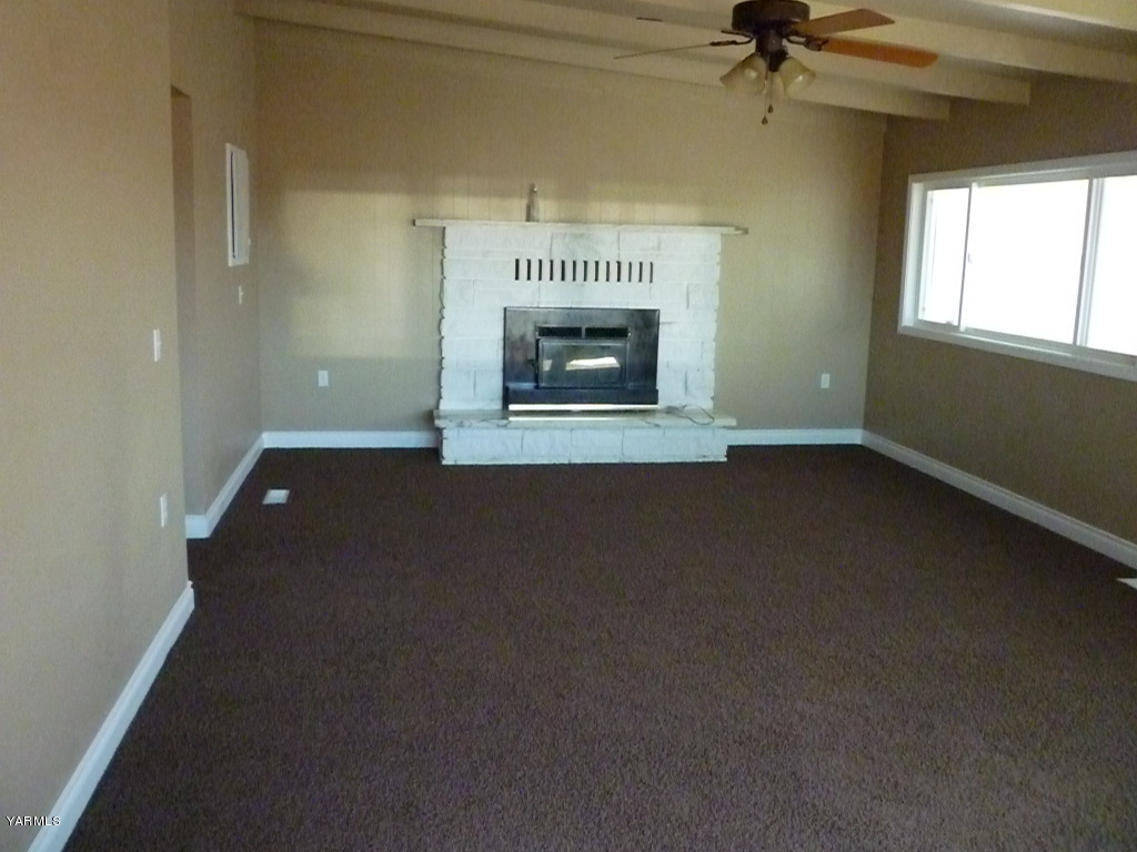 3020 Fort Road Toppenish, WA 98948 - Photo 23 of 37 an empty room with a fireplace and windows