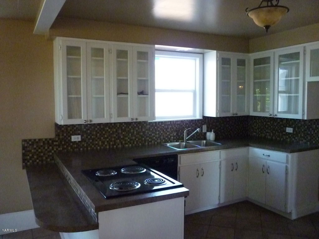 3020 Fort Road Toppenish, WA 98948 - Photo 9 of 37 a kitchen with a sink and a stove top oven