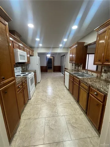 a kitchen with stainless steel appliances granite countertop a sink stove and cabinets