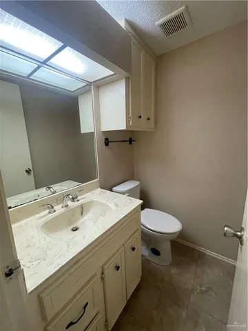 a bathroom with a sink toilet and mirror