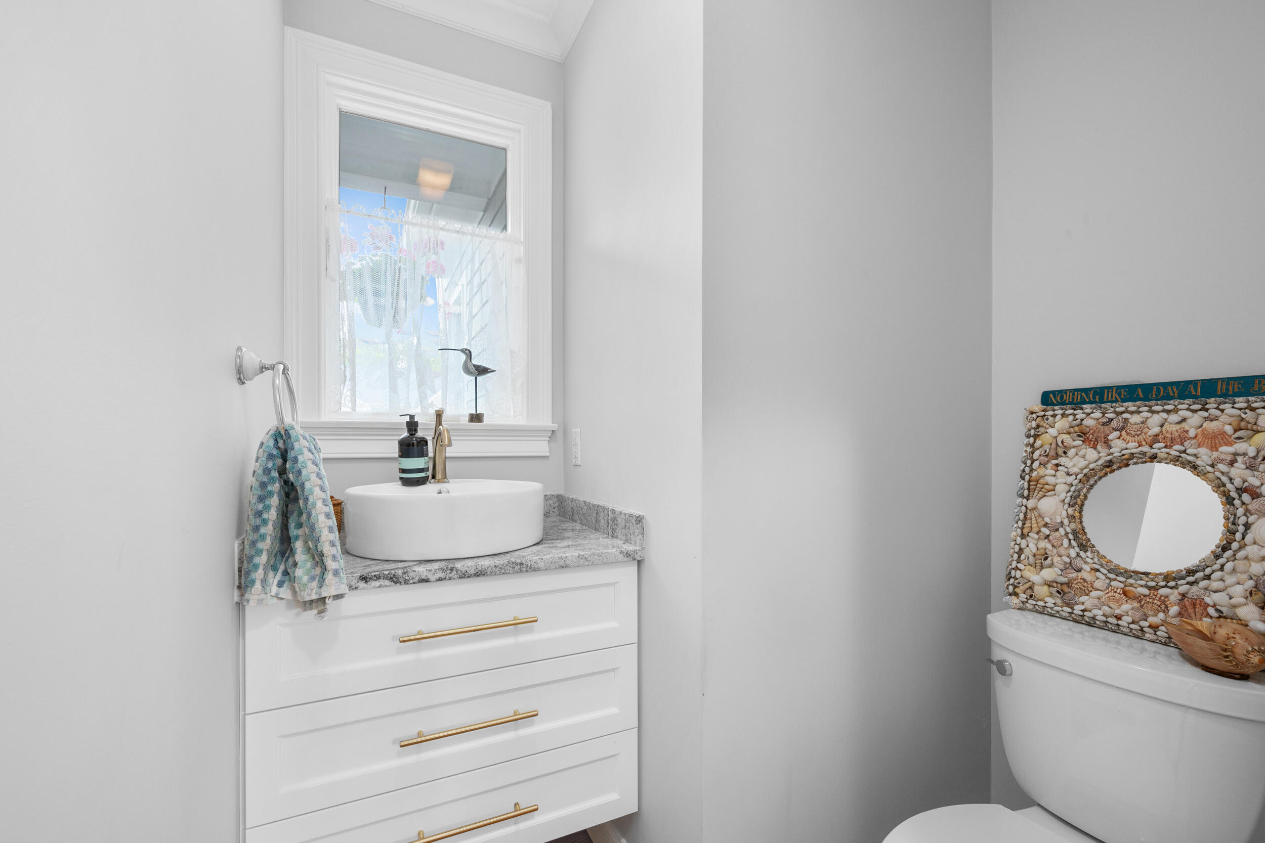 35 Bayshore Drive Mashpee, MA 02649 - Photo 20 of 55 a bathroom with a granite countertop toilet sink and mirror