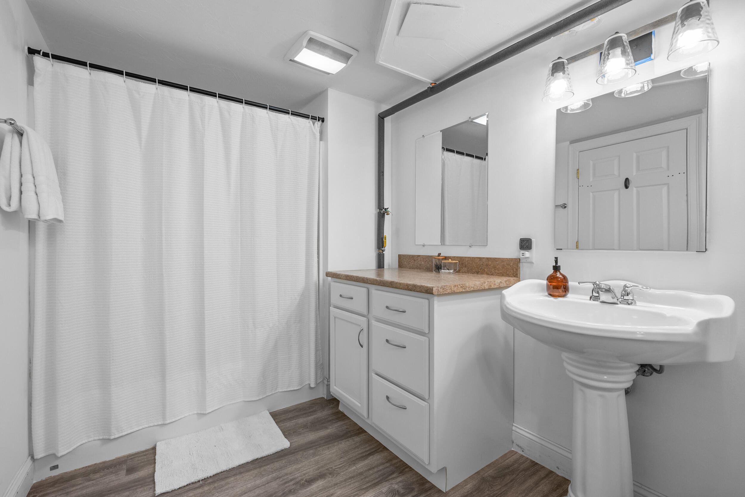 35 Bayshore Drive Mashpee, MA 02649 - Photo 33 of 55 a bathroom with a sink a mirror and a shower