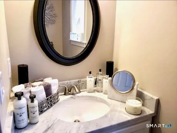 a bathroom with a mirror a sink and a mirror