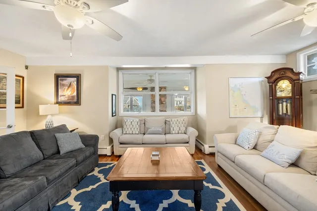 a living room with furniture a rug and a window