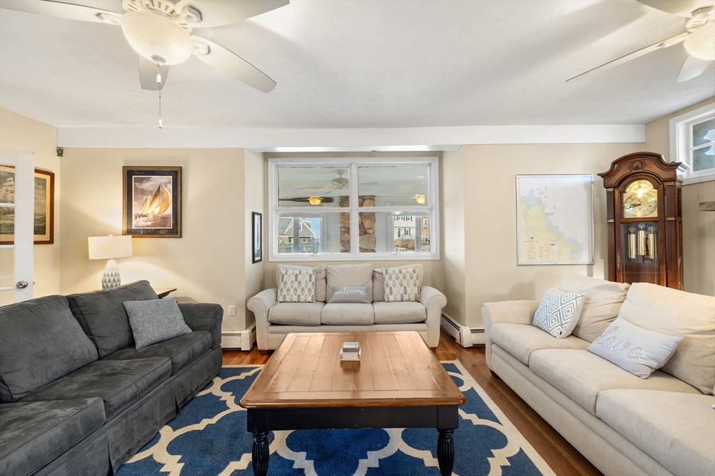 23 Oceanside Drive Scituate, MA 02066 - Photo 11 of 39 a living room with furniture a rug and a window