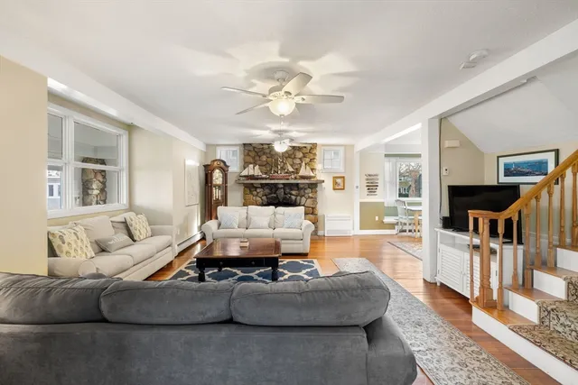 a living room with furniture a fireplace and a chandelier