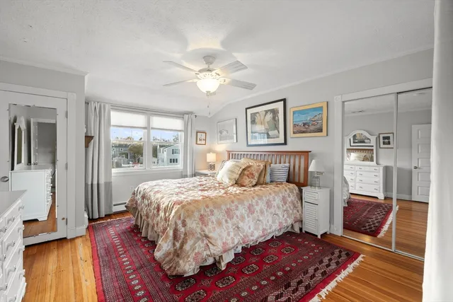 a bedroom with a large bed chandelier and a window