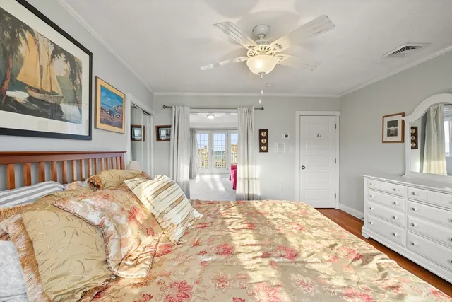 a bedroom with a large bed and a chandelier
