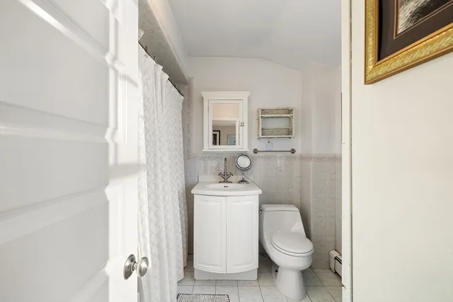 a white toilet sitting next to a bathroom sink
