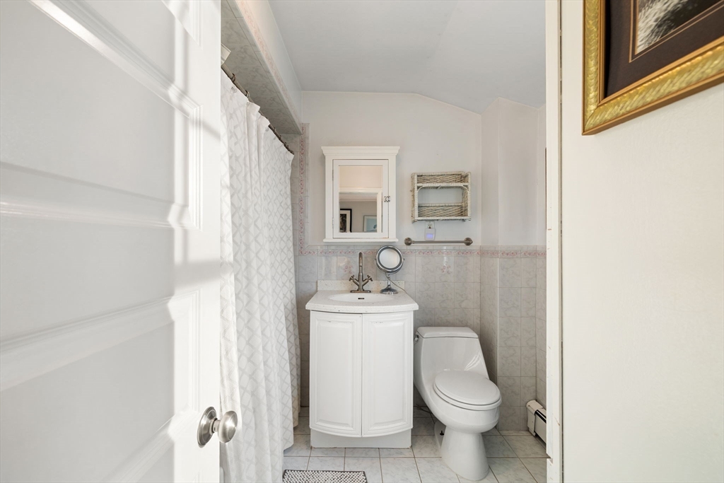 23 Oceanside Drive Scituate, MA 02066 - Photo 22 of 39 a white toilet sitting next to a bathroom sink