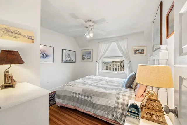 a bedroom with a bed and a lamp on dresser