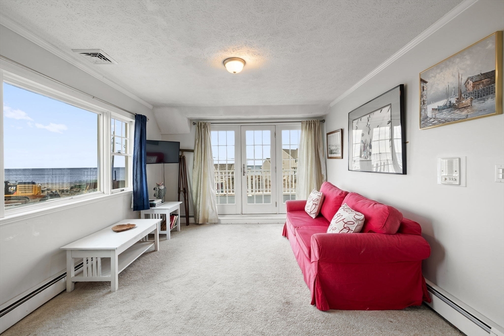 23 Oceanside Drive Scituate, MA 02066 - Photo 32 of 39 a living room with furniture and a large window
