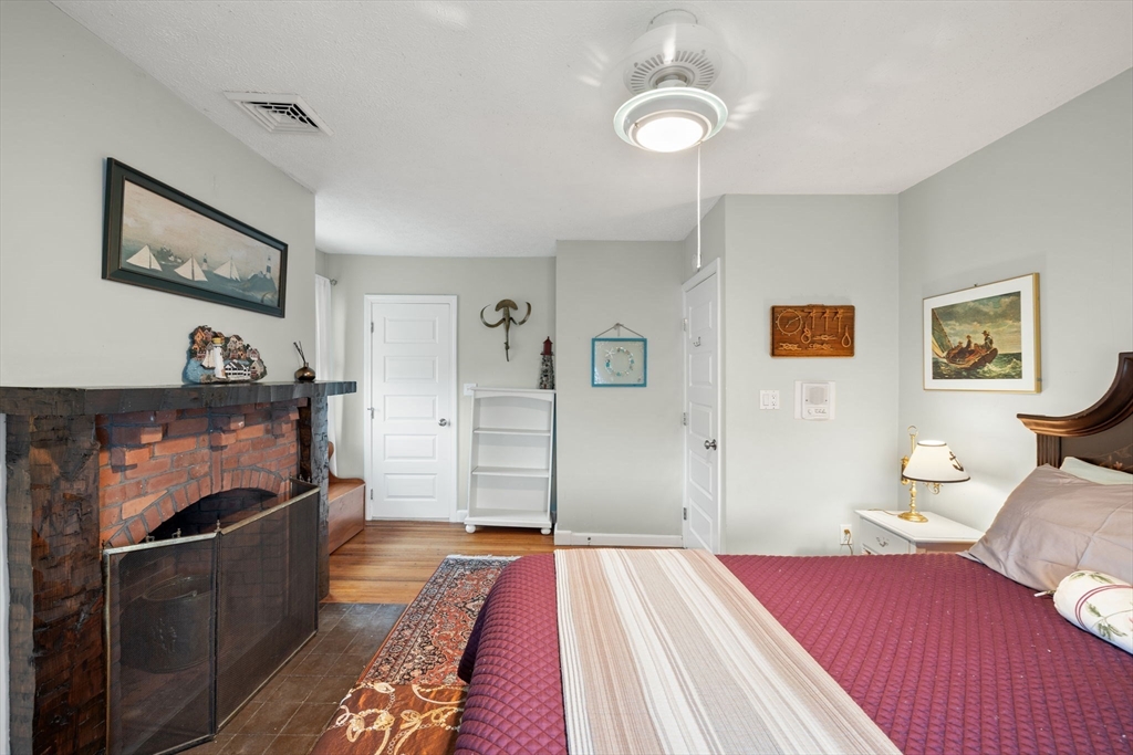 23 Oceanside Drive Scituate, MA 02066 - Photo 35 of 39 a bedroom with a bed and a chandelier