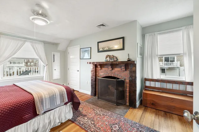 a bedroom with a bed and a fireplace