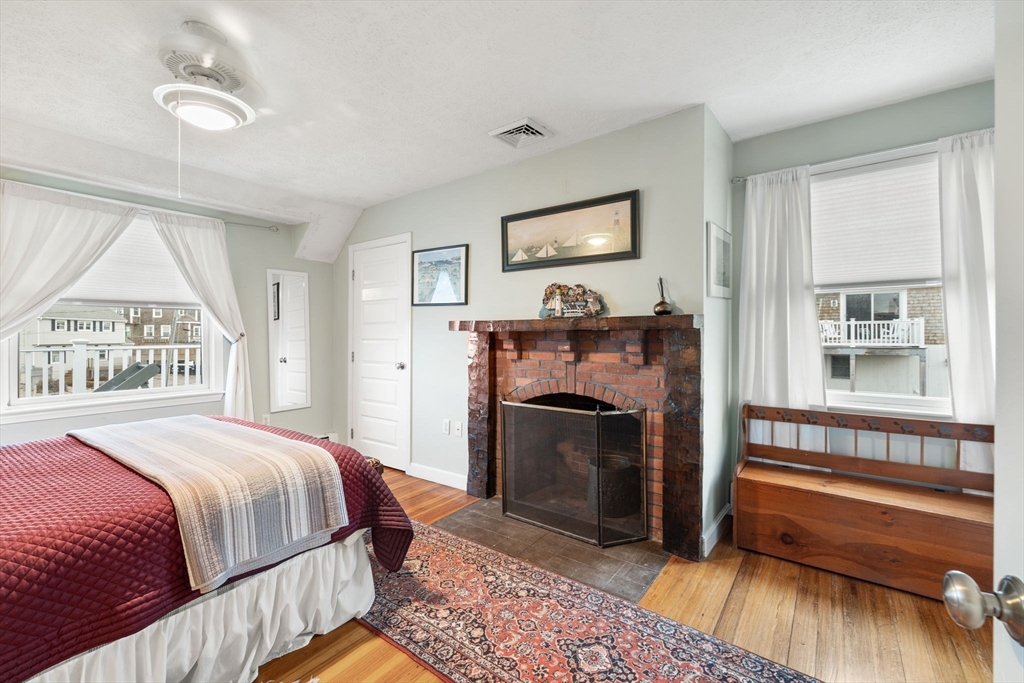 23 Oceanside Drive Scituate, MA 02066 - Photo 37 of 39 a bedroom with a bed and a fireplace