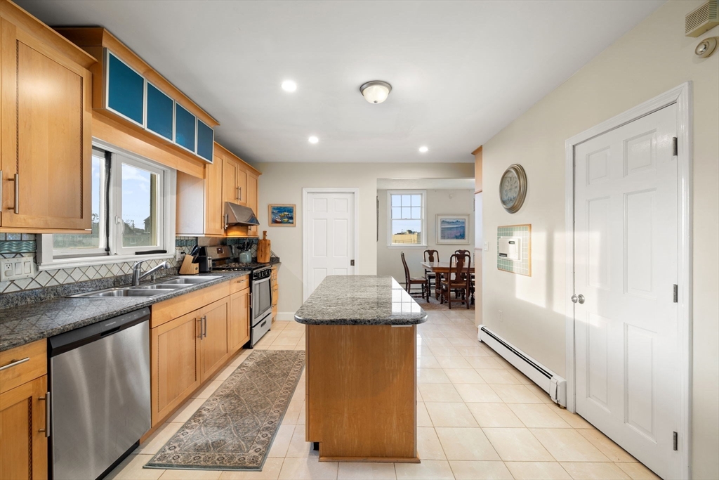 23 Oceanside Drive Scituate, MA 02066 - Photo 8 of 39 a large kitchen with granite countertop a large counter top stainless steel appliances a sink and cabinets