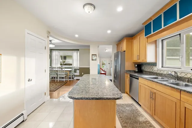 a kitchen with sink stove and refrigerator
