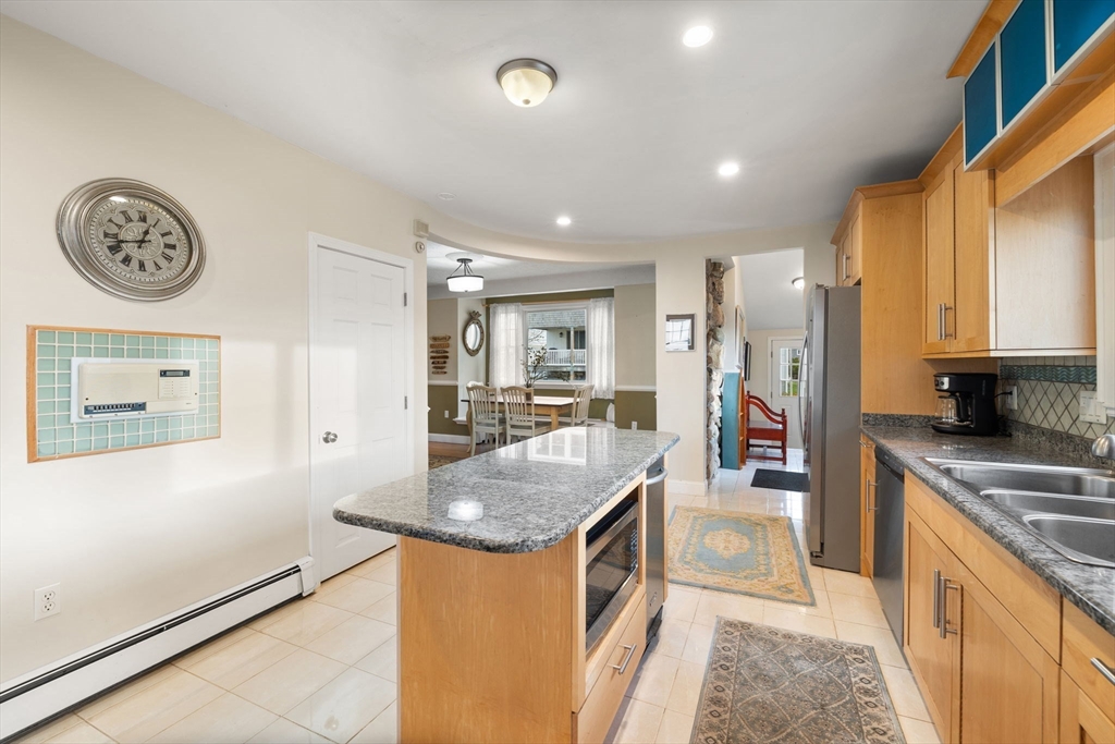 23 Oceanside Drive Scituate, MA 02066 - Photo 10 of 39 a kitchen with stainless steel appliances granite countertop a sink and a refrigerator