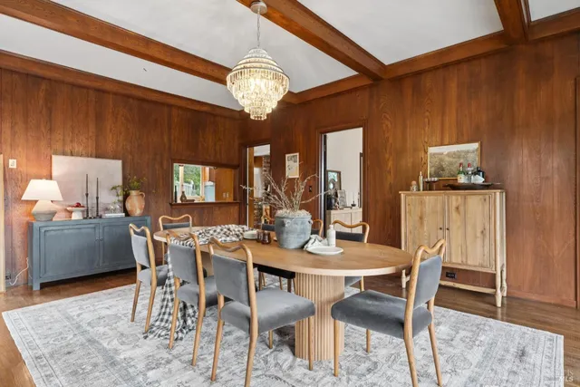 a view of a dining room with furniture and chandelier