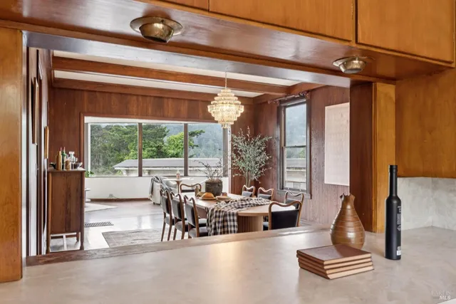 a living room with furniture and floor to ceiling windows
