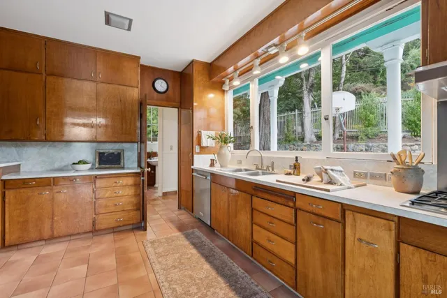 a kitchen with stainless steel appliances granite countertop a sink and cabinets