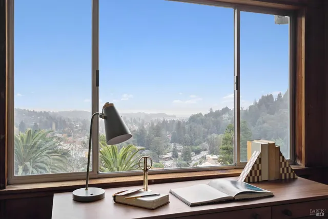 a view of a floor to ceiling window and a room with wooden floor