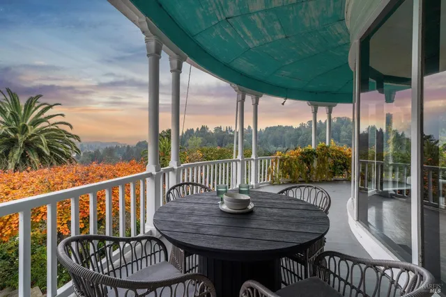 a view of a chairs and table in the balcony