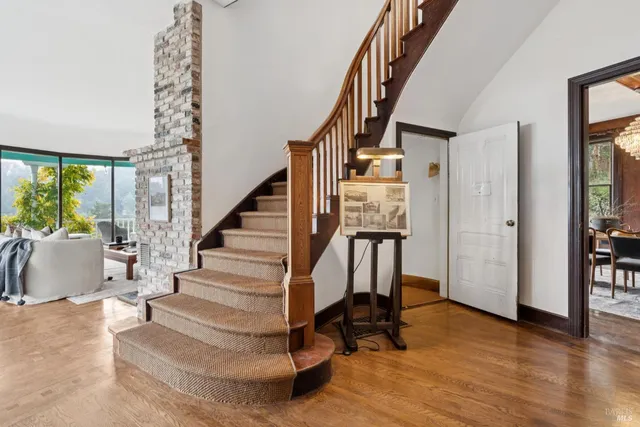 a view of entryway with wooden floor and stairs