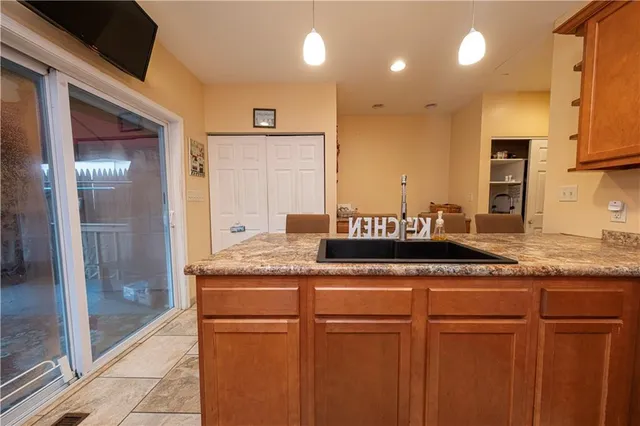 a bathroom with a granite countertop sink a toilet and a shower