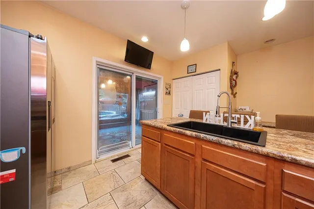 a kitchen with granite countertop a sink and cabinets