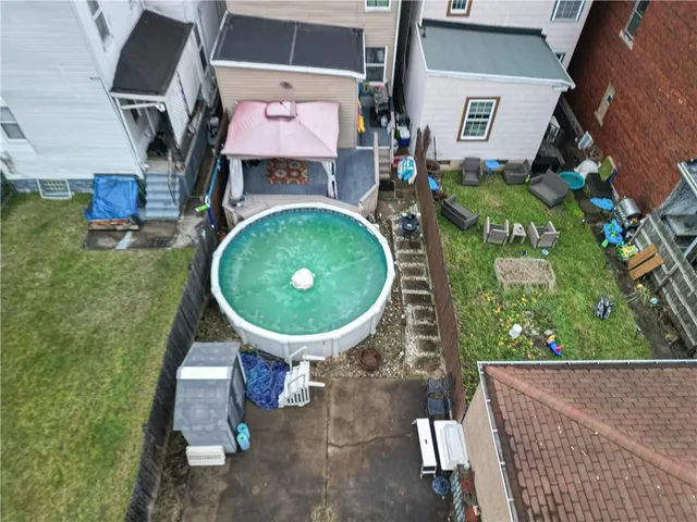 an aerial view of a house with garden space and outdoor seating