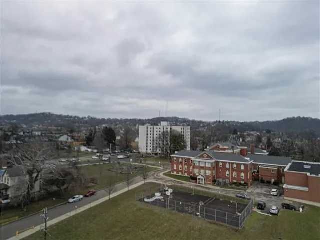 a view of a lake with lawn chairs and a view of city